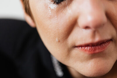 Woman cyring with tear running down her cheek